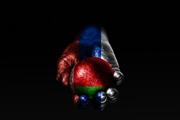 A hand with a drawn Russia flag holds a ball with a drawn Belarus flag, a sign of influence, pressure or conservation and protection.