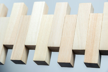 abstract geometric figure from wooden cubes, on an uneven white background. Horizontal frame