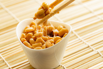 Eating healthy traditional japanese fermented soybeans called natto with chopsticks - 267682672