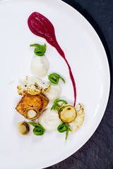 Pan fried salmon with pea, beetroot and cauliflower puree, roast leeks, cauliflower and asparagus ribbons