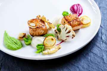 Pan fried salmon with pea, beetroot and cauliflower puree, roast leeks, cauliflower and asparagus ribbons