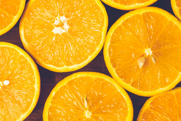 Orange background. Closeup of half cut fruits