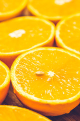 Fototapeta na wymiar Orange background. Closeup of half cut fruits
