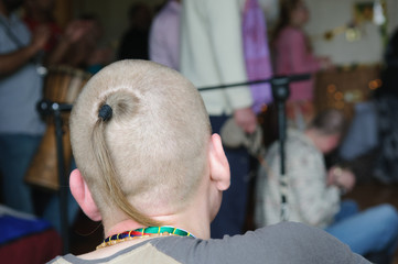 Hare Krishna sikha - a shaved head with a ponytail from the crown.