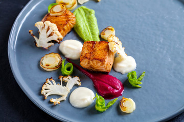 Pan fried salmon with pea, beetroot and cauliflower puree, roast leeks, cauliflower and asparagus ribbons