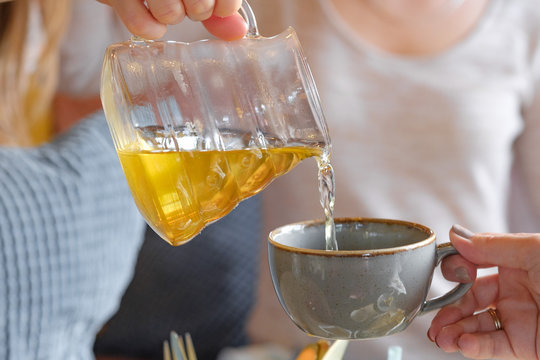 Tea being poured into tea cup - Powered by Adobe