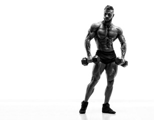 Handsome Young Body Builder Exercise With Dumbbells. Black and White Image