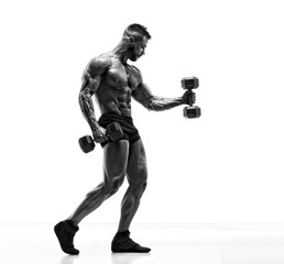 Fototapeta na wymiar Handsome Young Body Builder Exercise With Dumbbells. Black and White Image