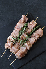 Raw skewers on wooden sticks.