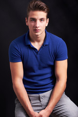 Obraz premium Elegant young handsome man posing on black background