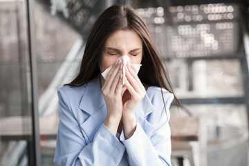 Flu. Young woman got nose allergy, flu sneezing nose.