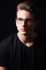 Obraz premium Portrait of elegant young handsome man isolated on black background