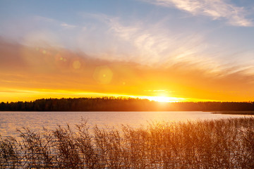Fototapeta na wymiar Beautiful sunset on the lake in the autumn evening - Image