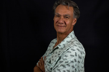 Portrait of a Middle Aged Mature Man Aganist a Black Background