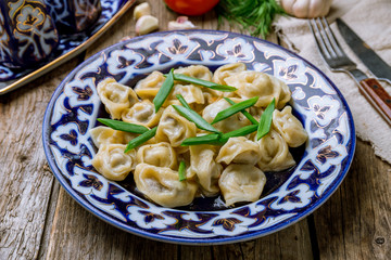 Dumplings chuchvara Uzbek cuisine on wooden background