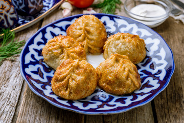 fried manty uzbek cuisine on wooden background