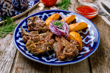 Kazan kebab on plate on wooden background