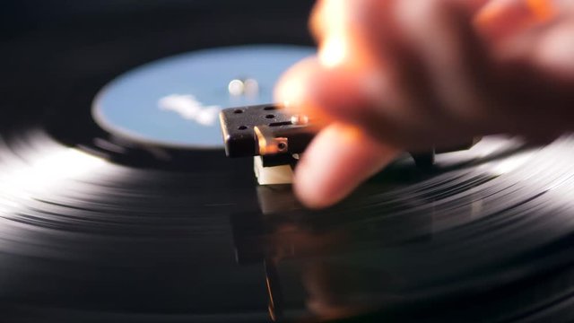 Tone arm is being put onto a static vinyl record