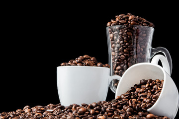 Black coffee in white cup and coffee beans on black background. Top view, space for text