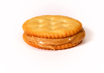 Side view of Natural organic peanut butter filling and oozing out of this sandwich made with golden...