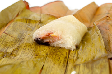 Show inside of Bananas with Sticky Rice (Khao Tom Mat or Khao Tom Pad in thai). Native Thai desert wrapped with banana leaves and then steamed isolated on white background.