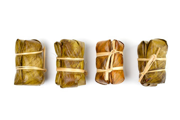 Group of Bananas with Sticky Rice (Khao Tom Mat or Khao Tom Pad in thai). Native Thai desert wrapped with banana leaves and then steamed isolated on white background.