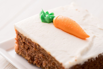 Carrot cake slice with frosting carrot topper