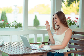 Student woman having a video call with a laptop computer