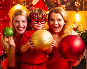 Christmas family fun. Christmas party. Women red dresses festive mood celebrate christmas with...
