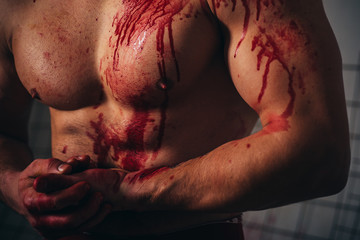 Mutant concept. Psycho mad man. Murderer brutal aggressive guy. Aggressive person. Injured soldier. Chest muscular torso with bloody streams. Pain and gain. Pain and injury. Body soiled blood © Volodymyr