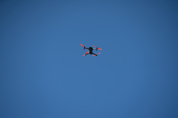 Fototapeta na wymiar Drone flying on a blue sky