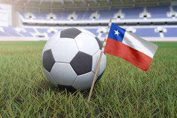 Chilean flag in stadium field with soccer football