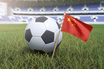 Naklejka premium Chinese flag in stadium field with soccer football