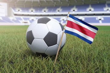 Fototapeta premium Costa Rican flag in stadium field with soccer football