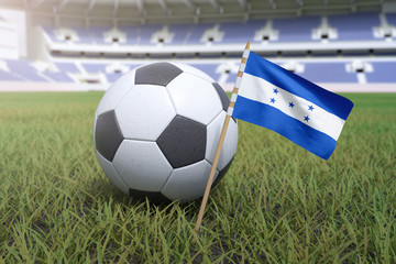 Honduras flag in stadium field with soccer football
