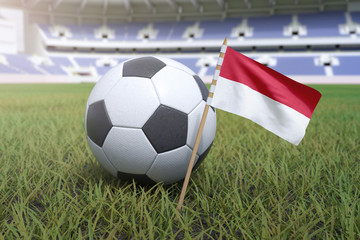 Naklejka premium Indonesian flag in stadium field with soccer football