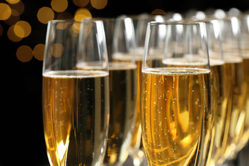 Many glasses of champagne on blurred background, closeup