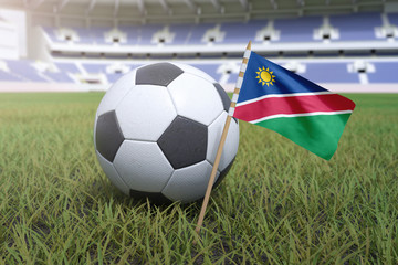 Fototapeta premium Namibia flag in stadium field with soccer football