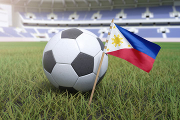 Fototapeta premium Filipino flag in stadium field with soccer football