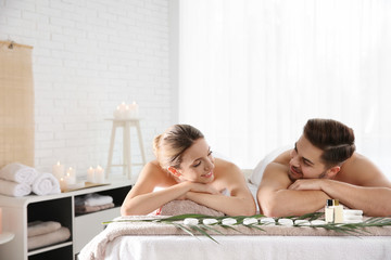 Obraz na płótnie Canvas Romantic young couple relaxing in spa salon