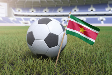 Suriname flag in stadium field with soccer football