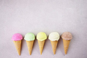 Set of various ice cream scoops in waffle cones. Food background, refreshment, rainbow, variety, cool seasonal sweets, refreshment concept