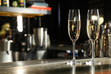 Glasses of champagne on counter in bar. Space for text