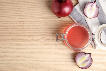 Flat lay composition with onion syrup in jar and space for text on table