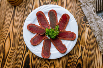 Dried sliced basturma on the Board