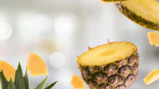 Pineapple with Slices Falling on Kitchen Background