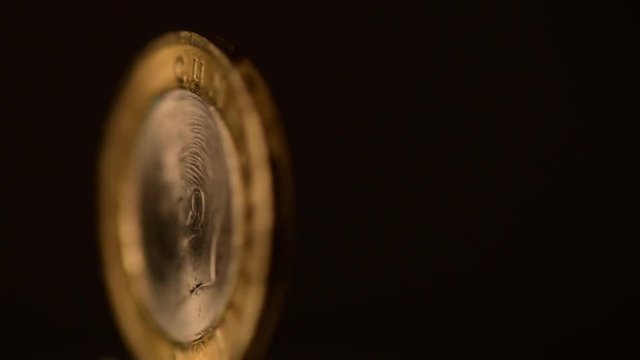 One Turkish Lira Coin is rotating on a black background.