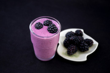 Fototapeta na wymiar Acai Smoothie with fresh blackberries in the glass cup