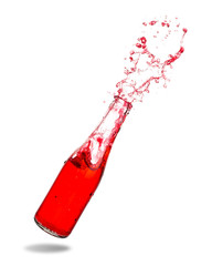 Red soda splashing out of glass bottle isolated on white background.