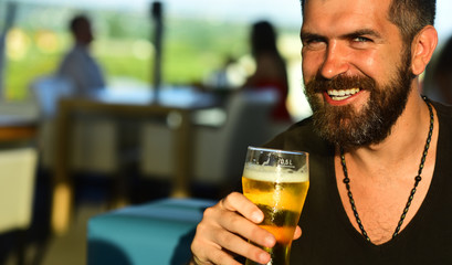 Retro advertising of alcoholic beverages. Emotional funny bearded drunk hipster holds craft bottled beer.